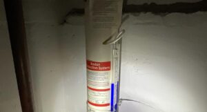 U-tube manometer on a radon reduction system pipe in a New Jersey basement